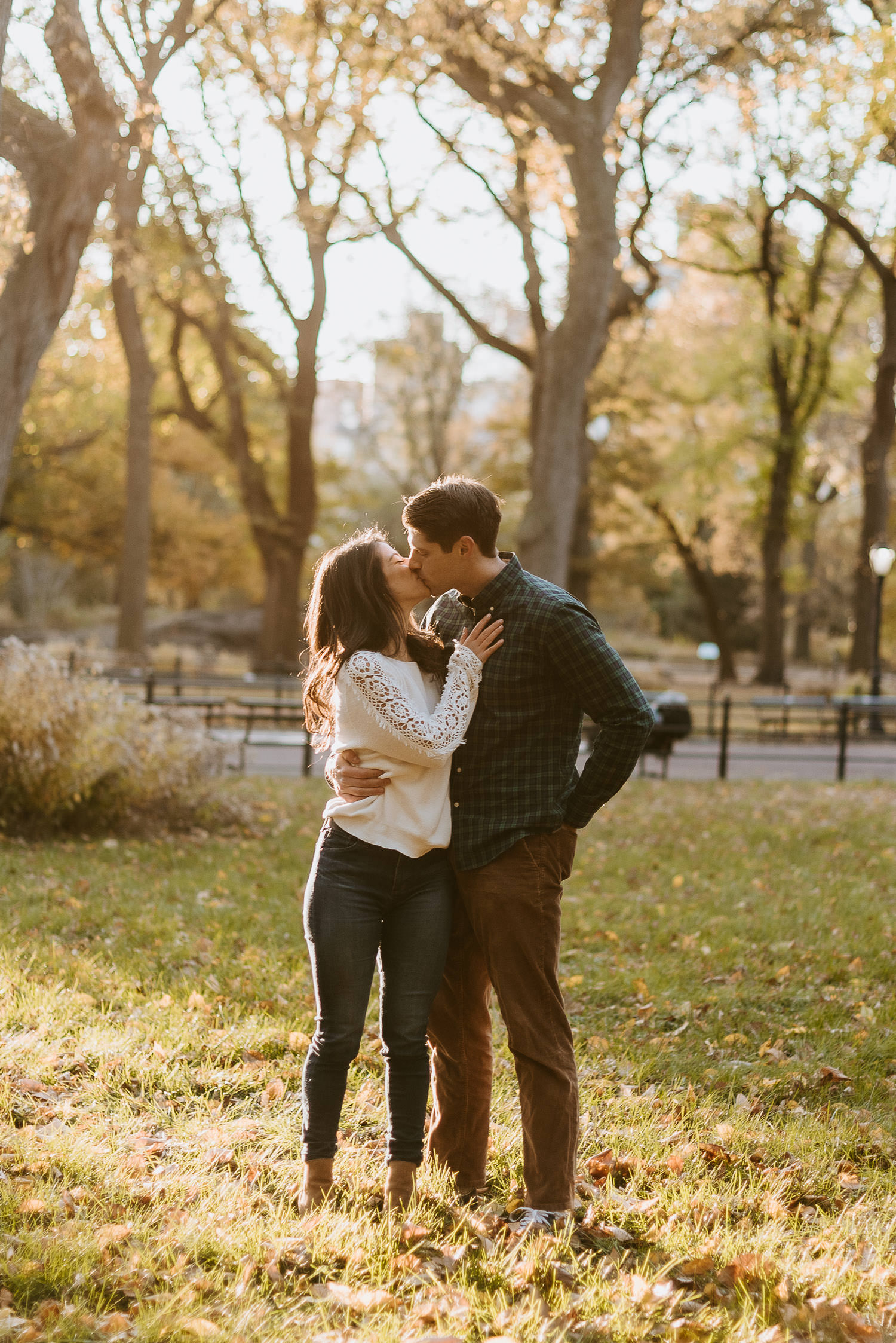 engaged couple kisses in central park during their engagement session