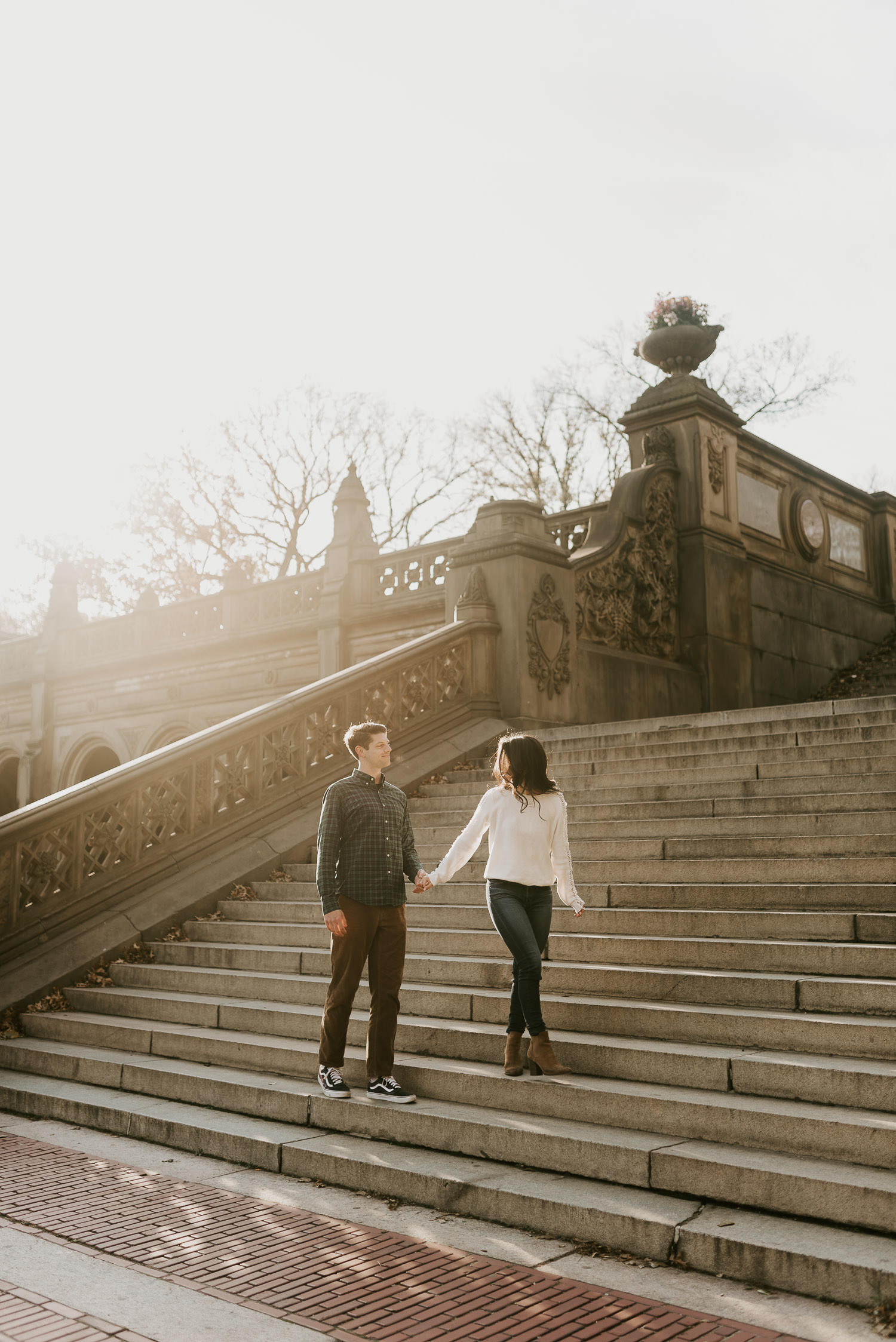engaged couple on the steps of bethesda terrace in nyc central park